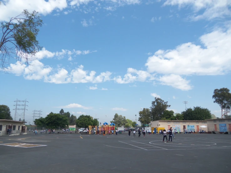 the parking lot at the back of the business, as people walk about