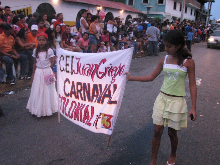 the girl is holding the banner for carnival