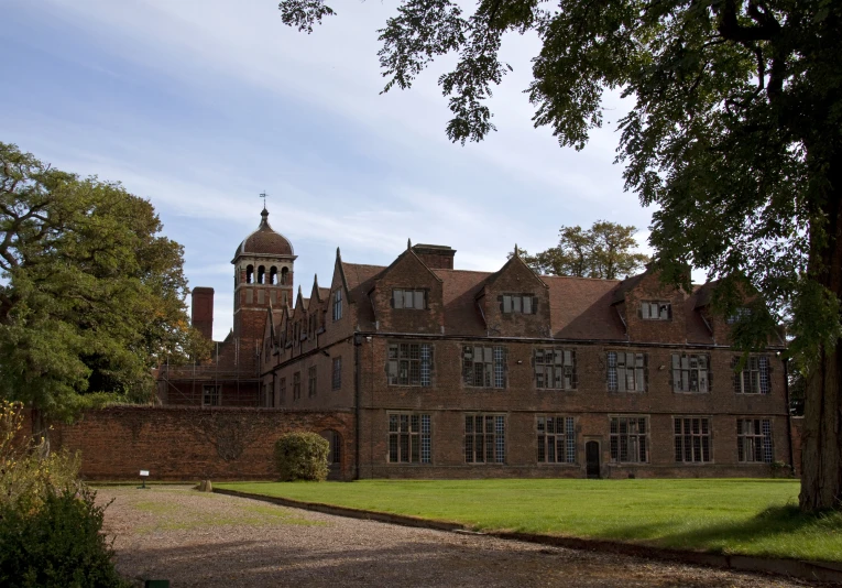 a large building with a tower, near the grass