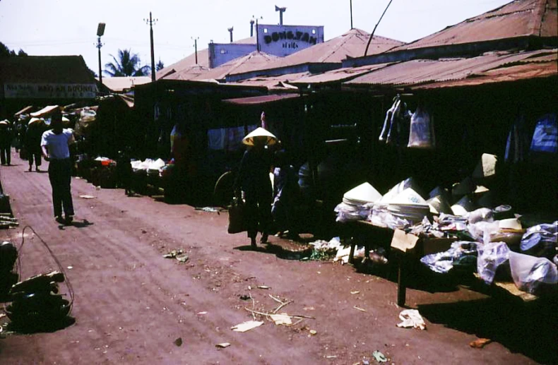 the people are walking through the city market