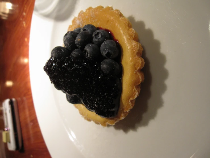 a piece of pastry that is covered in blueberries and blackberries