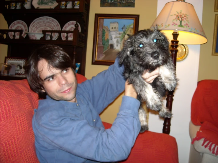 a man and his dog in the living room