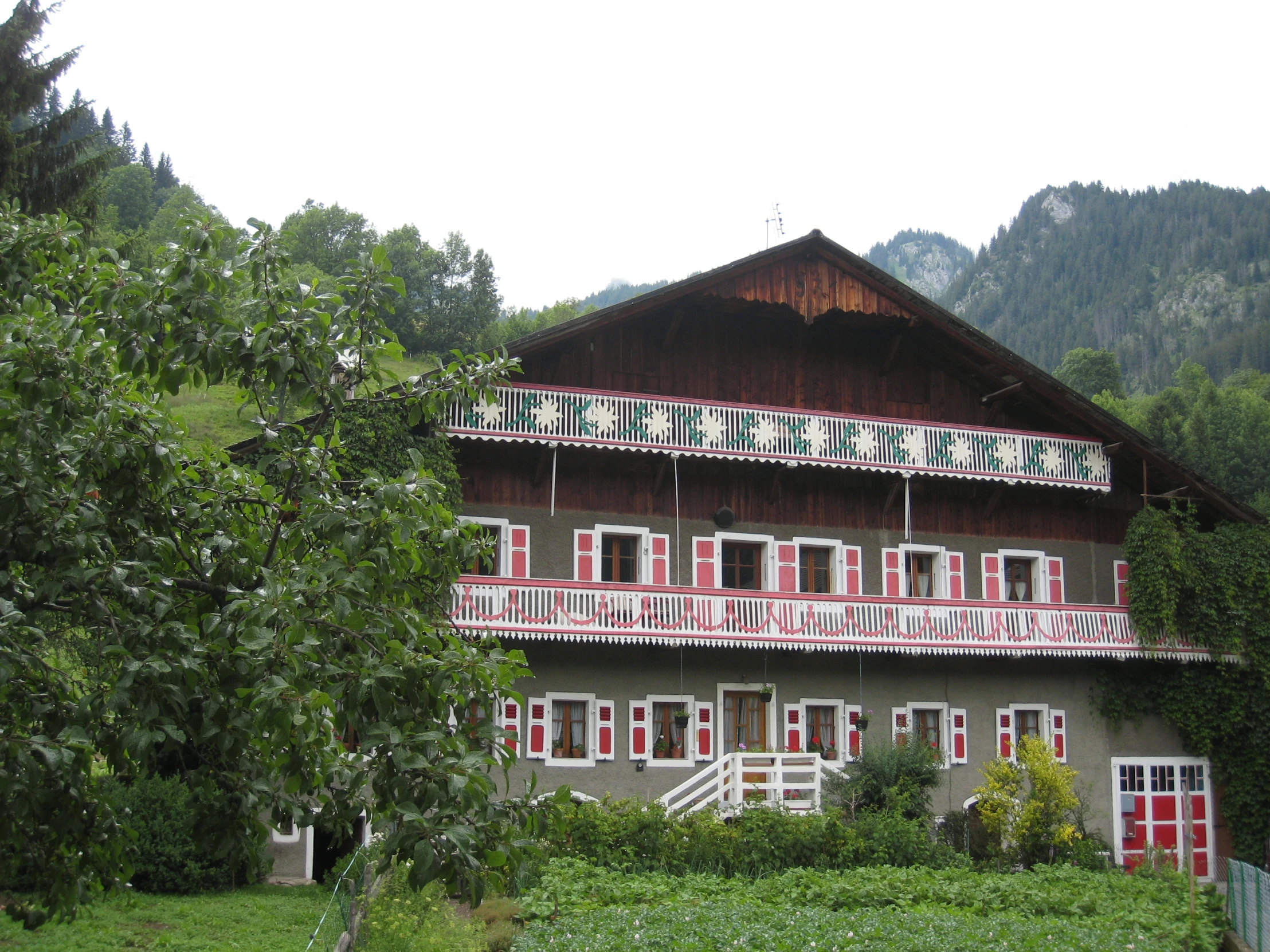 a house with lots of windows and white balconies