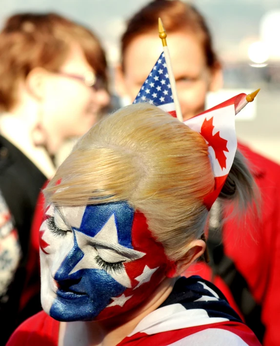 young child in patriotic themed face paint at outdoor event