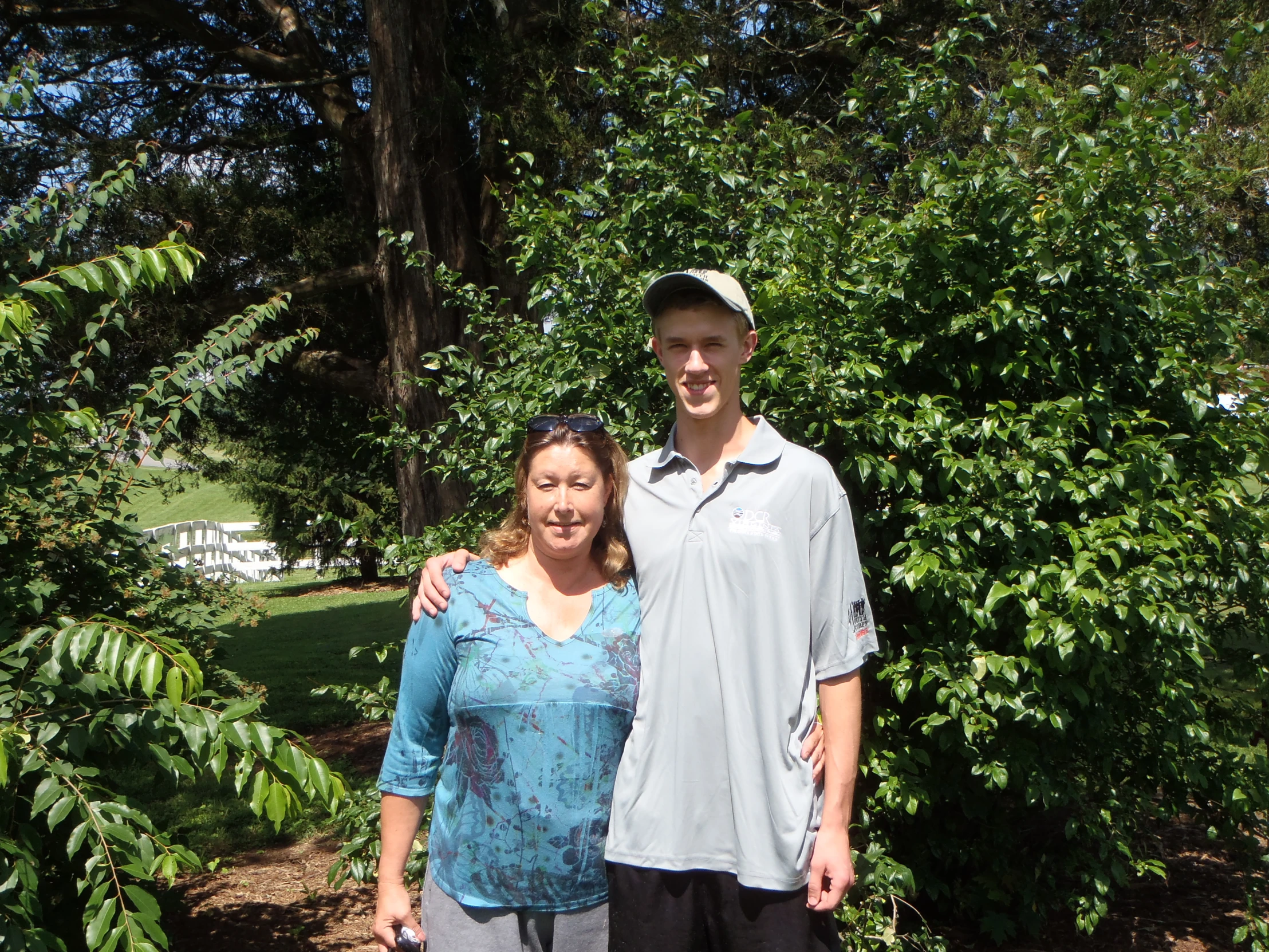 man and woman posing together in the woods