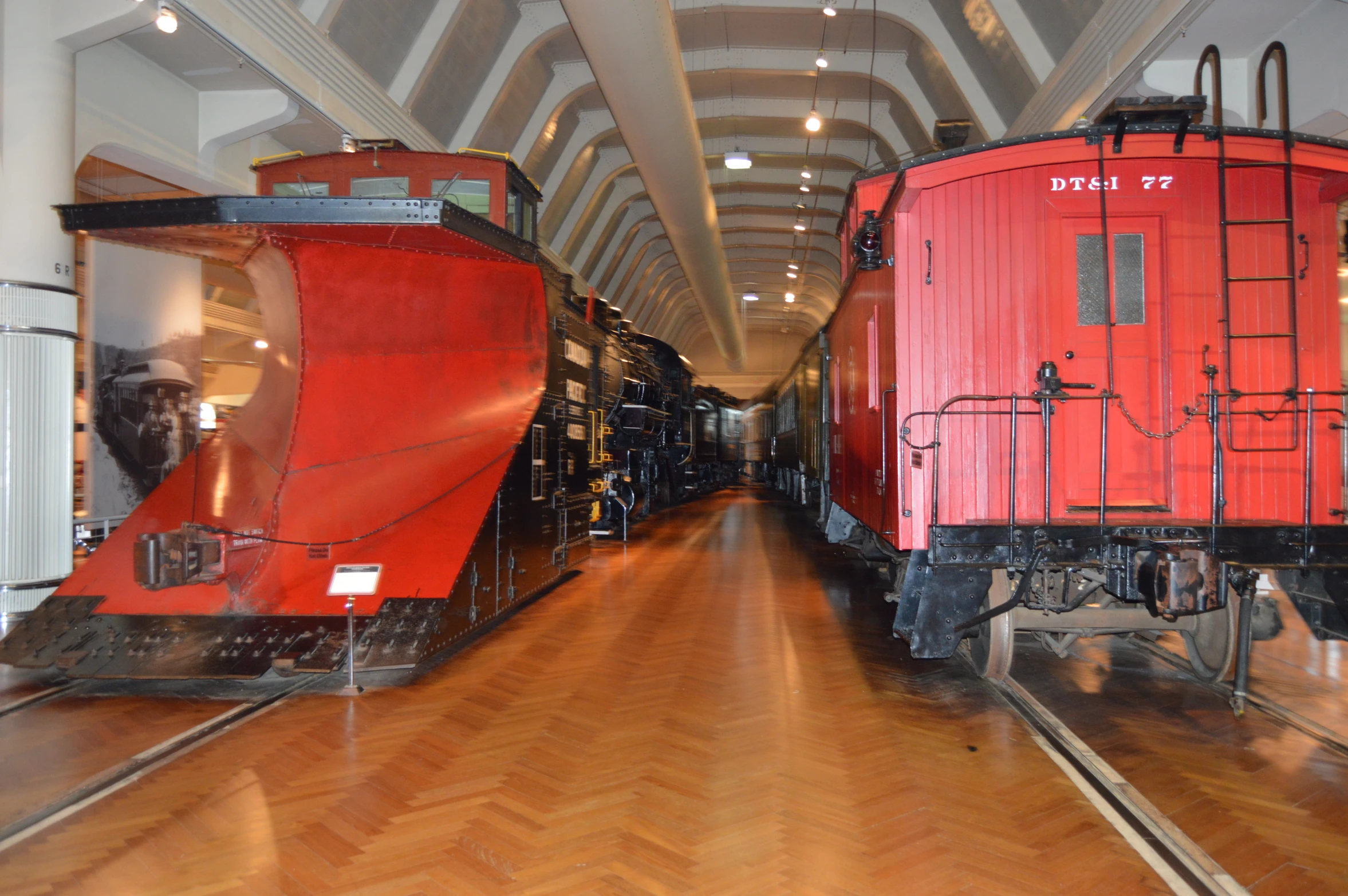 a long hallway with lots of red train cars