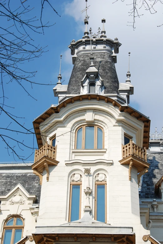 a building with a tower is shown against a blue sky