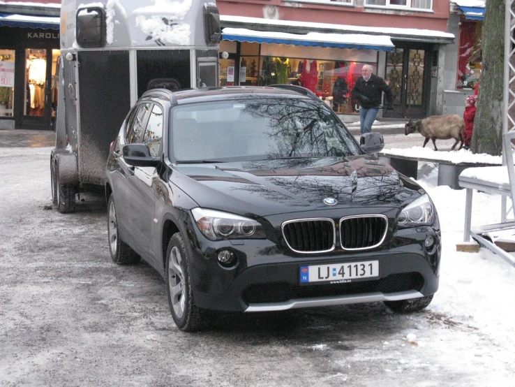 a black vehicle parked in front of a building