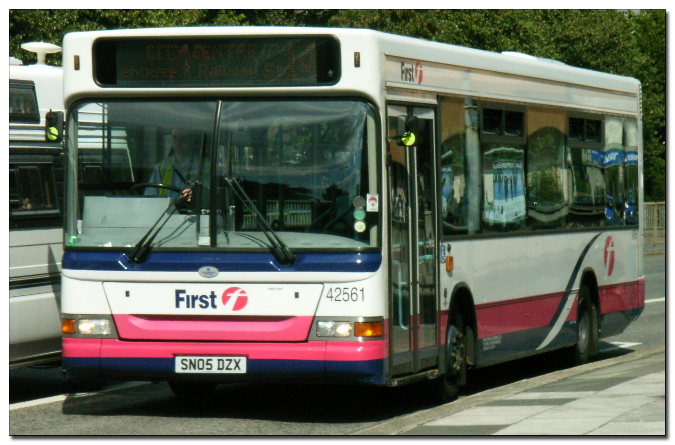 an image of a commuter bus at the stop