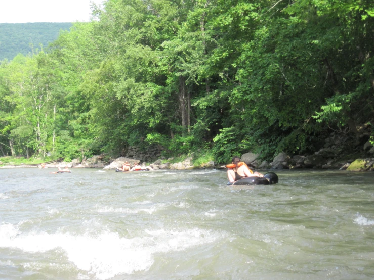 a man is tubing down the river