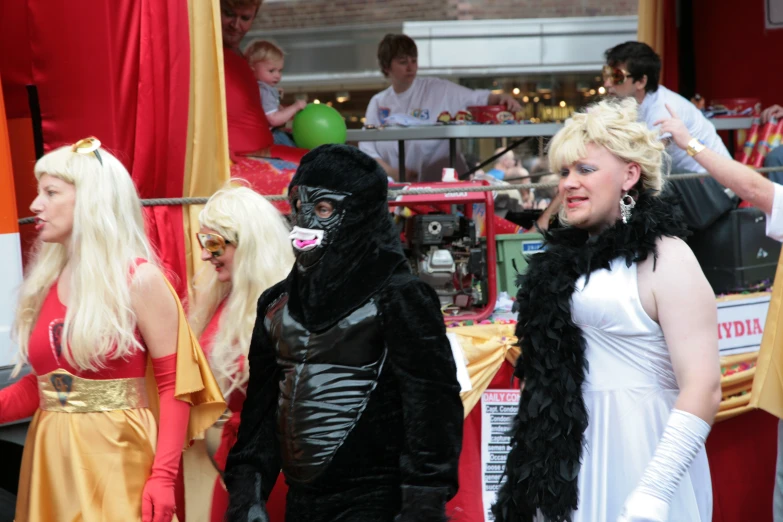 three people in costumes and masks standing next to each other