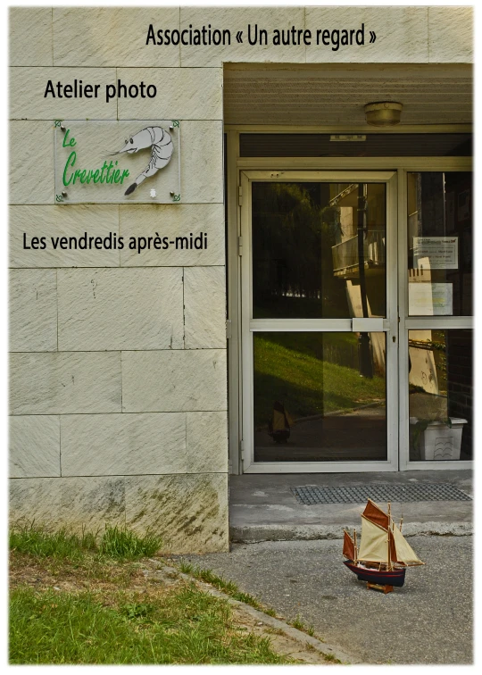 a po shop with a toy sail boat laying by the side