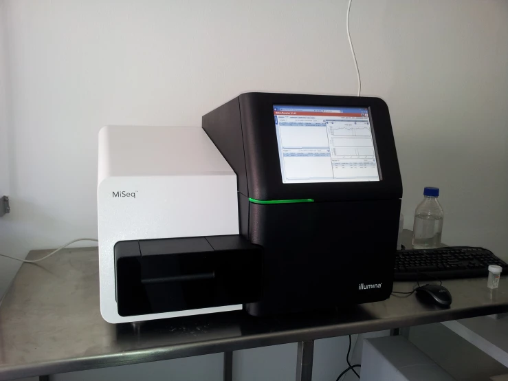 two machines sit on top of a desk