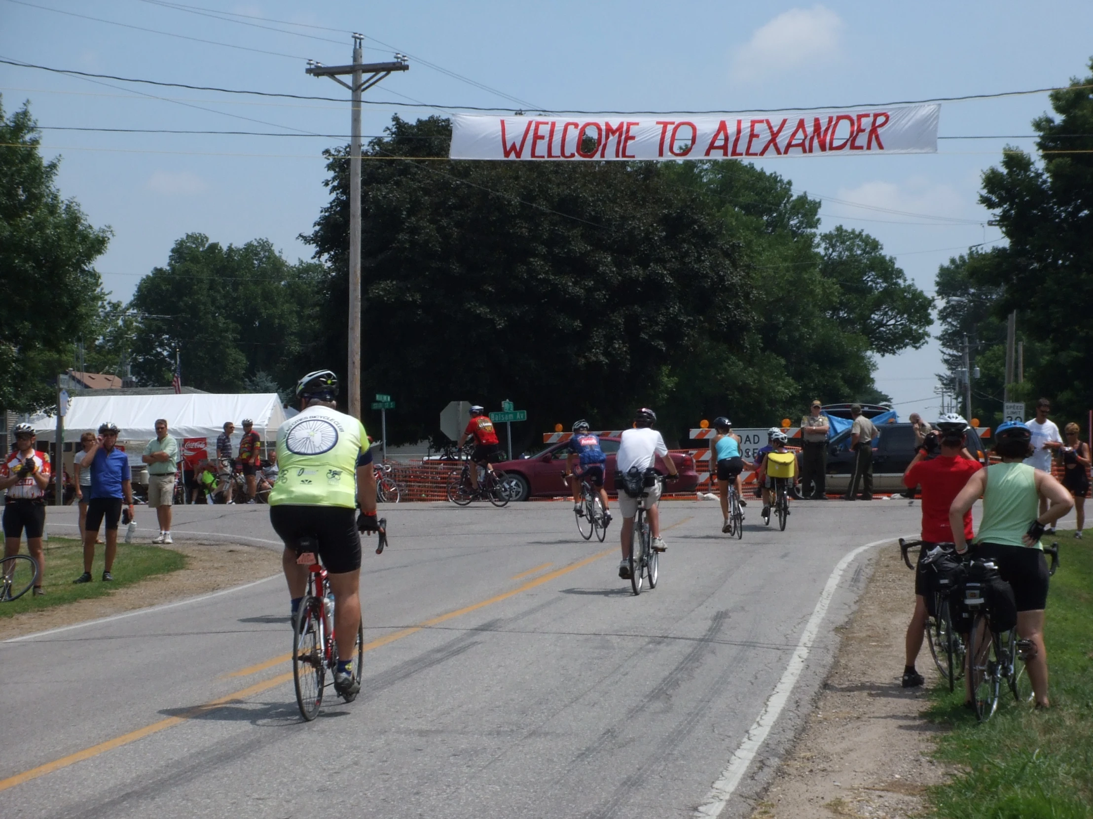 a bunch of people riding bicycles down a street