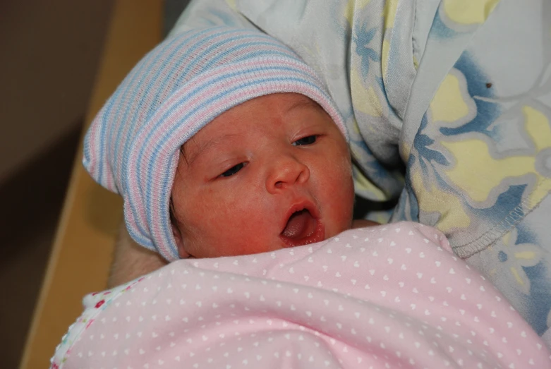 a newborn baby is laying down in its crib