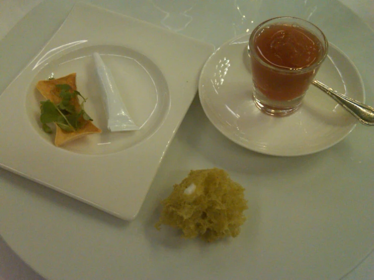 a small plate with a few slices of food and a drink