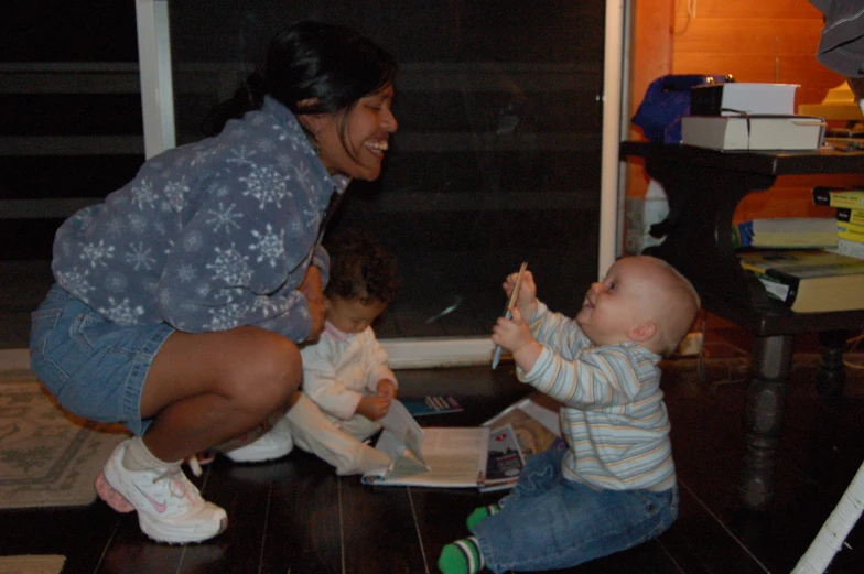 a woman standing over a child who is holding soing