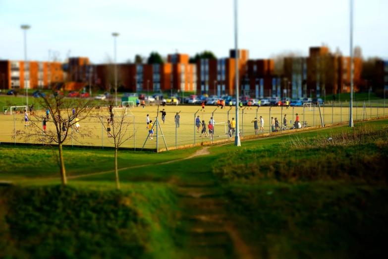 a school field that has a bunch of s playing soccer