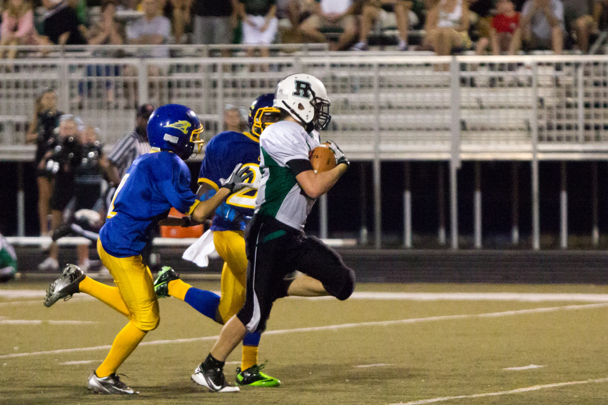 the football team is running in front of a player