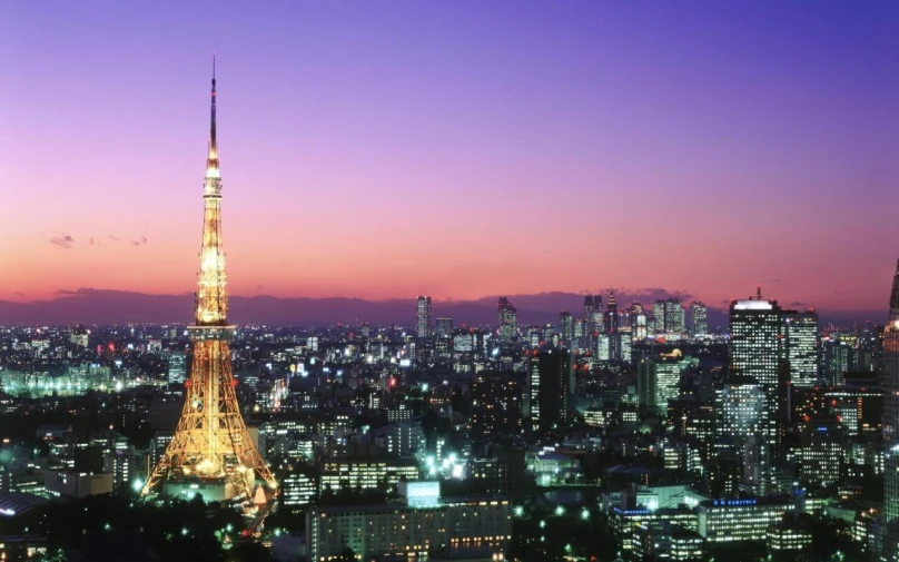 the city lights are lit up at dusk