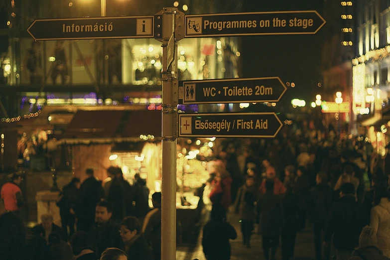 people walk through the street in the city during the night