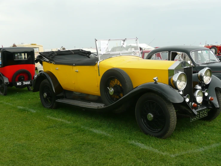 some very nice looking cars on a grassy field