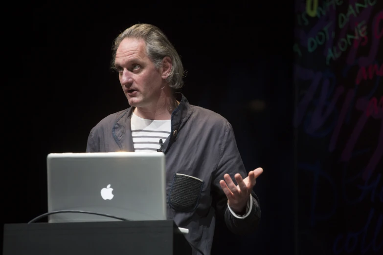 a man in the middle of an apple event