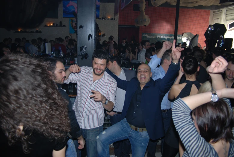 the group of friends is dancing together at a party