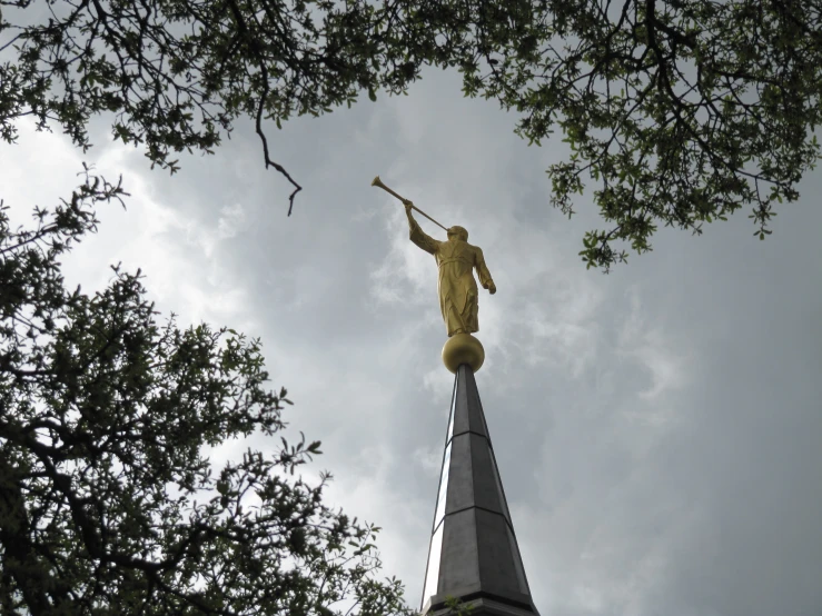 the statue is standing high in the trees