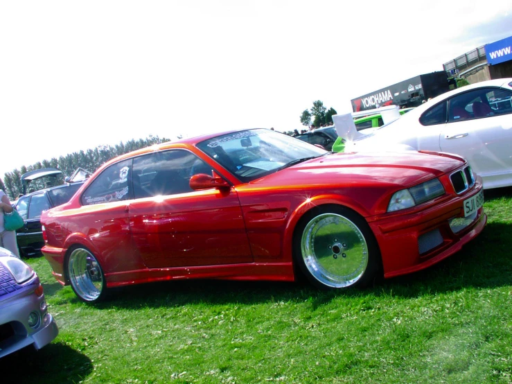 a red car parked on top of green grass