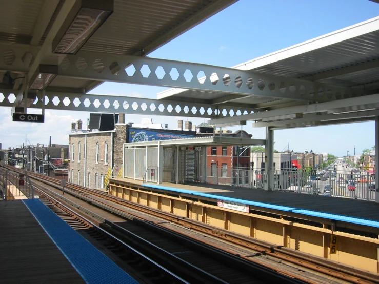 a long empty train station with a sky background