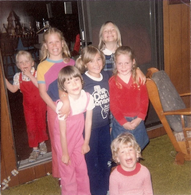 a group of little girls standing next to each other