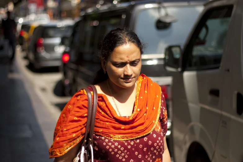 woman walking down the street, with a scarf over her shoulders