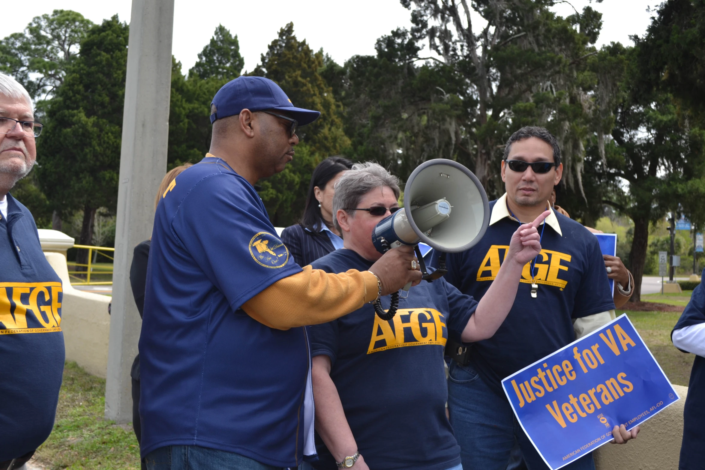 a man holding a megaphone to a crowd of people