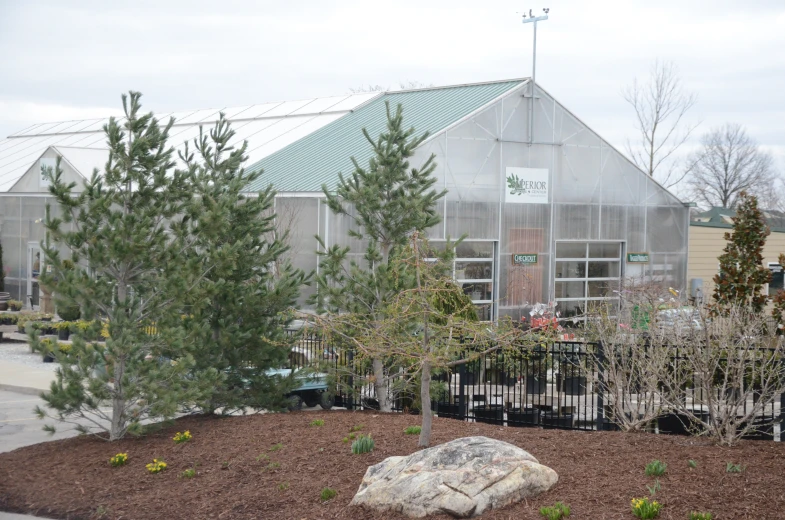 a building with green roofs in a small garden