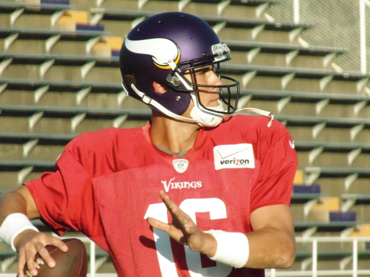 a person wearing a football uniform that is holding a ball