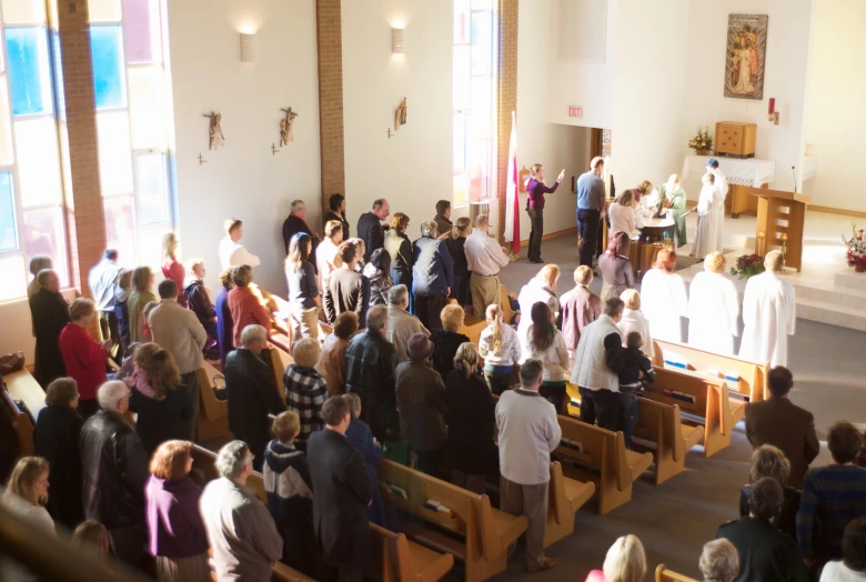 the people are standing in front of the alter