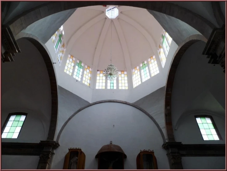 the beautiful ceiling of a church with three stained glass windows