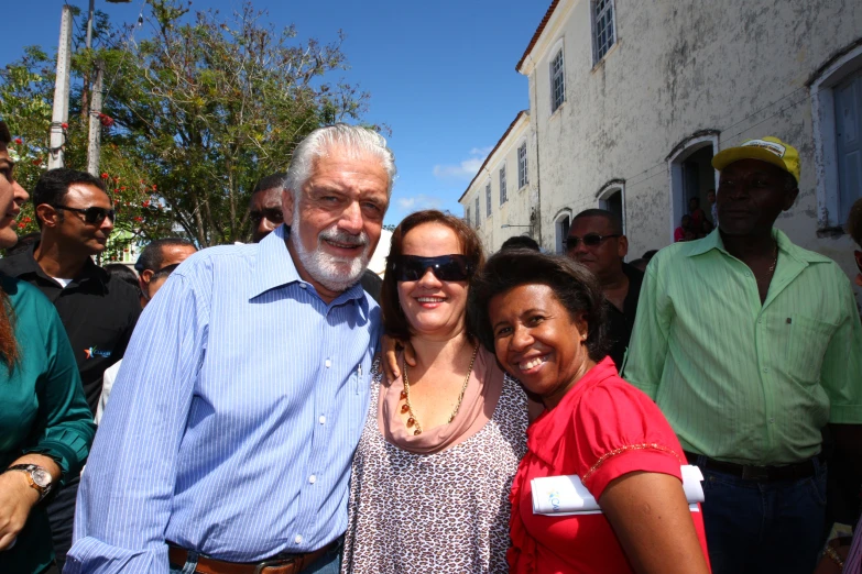 three people pose together at a street party