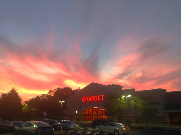 a building with a red light on it and red sky above