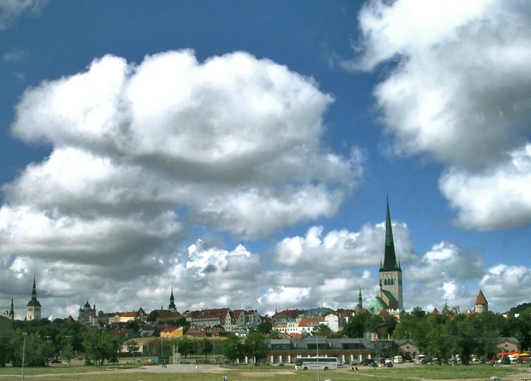 a city scene with clouds in the sky