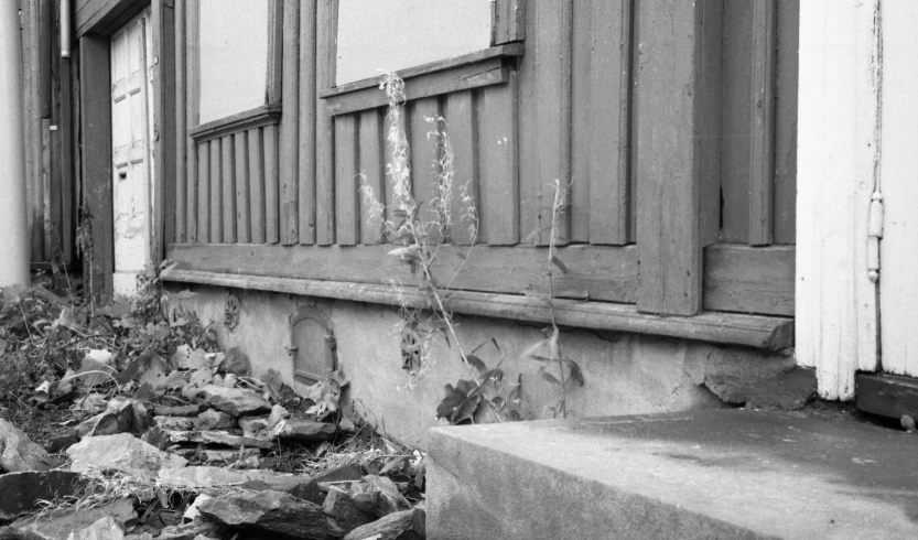 black and white po of debris in front of an old house