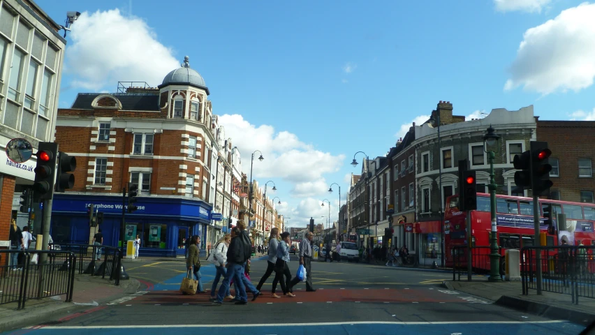 an intersection with several people and traffic lights