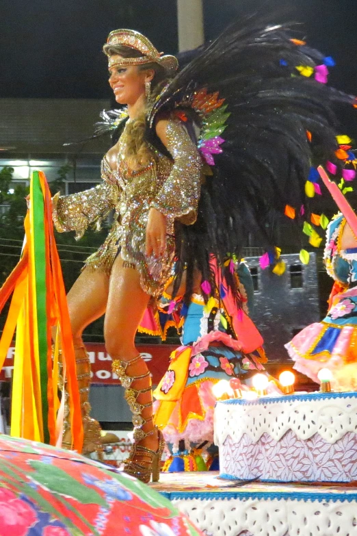 a lady that is standing in the street with a feathers