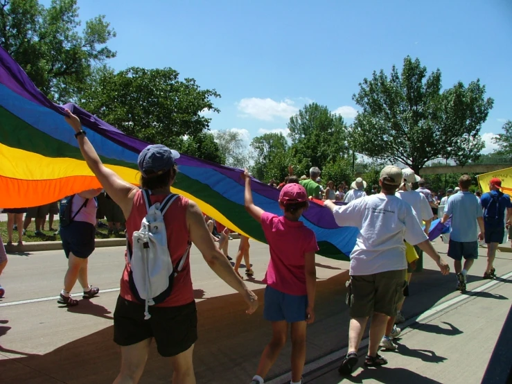 a group of people that are holding onto a kite