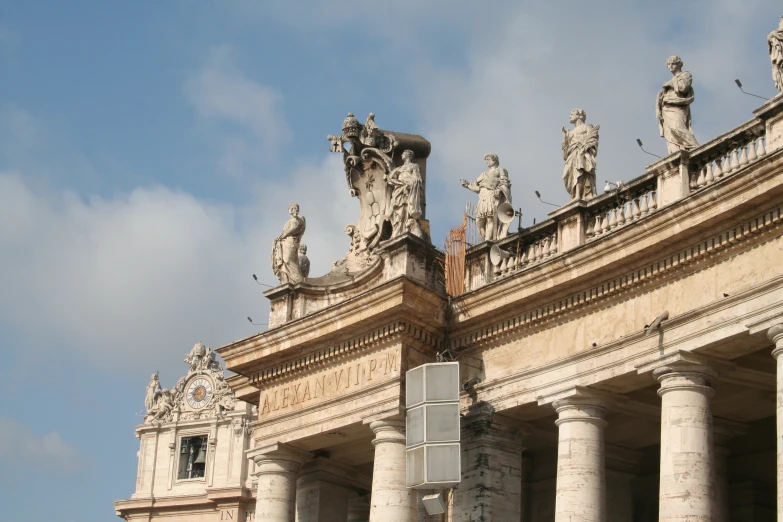 some very tall building with statues on top of it