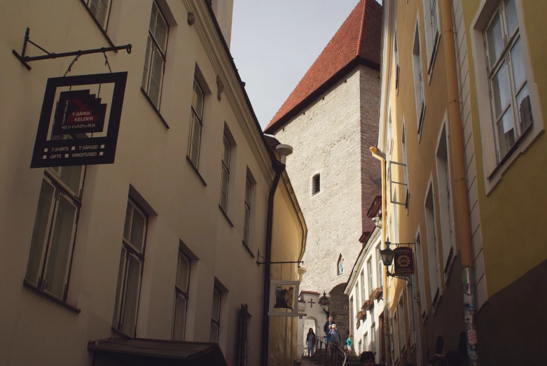 narrow street with lots of windows and tall buildings