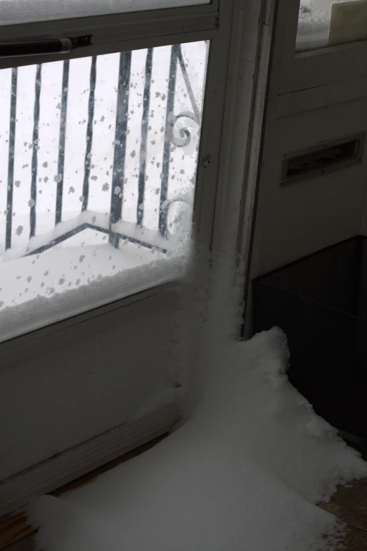 the view from outside the window of snow and the outside door