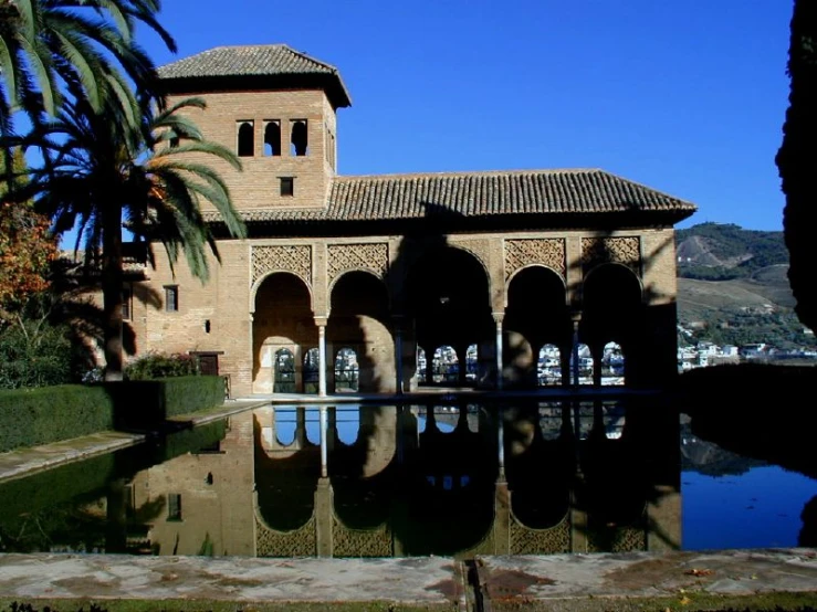 the buildings and trees near the pool are covered in stucco