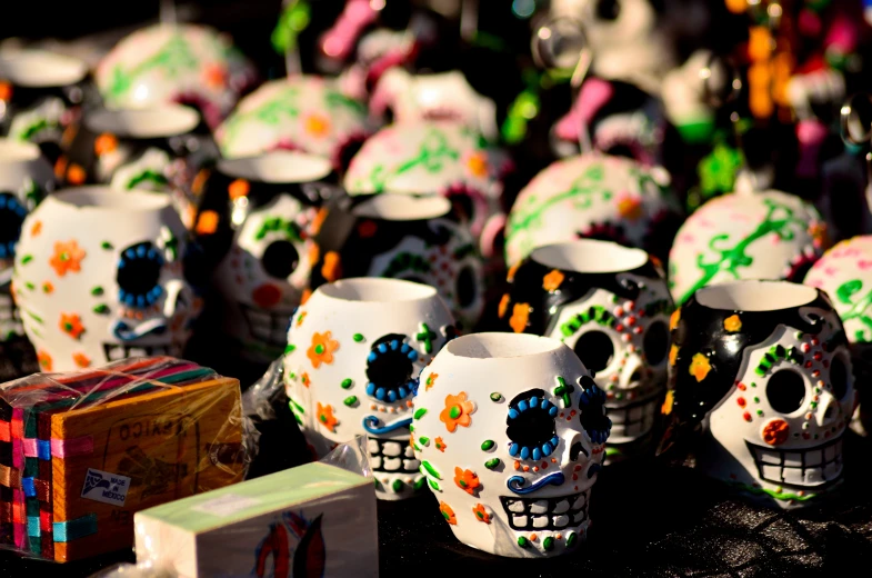 brightly colored skull vases on display at a shop